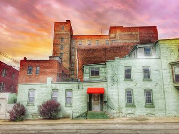Buildings against cloudy sky
