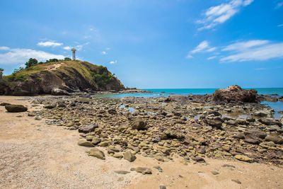 Rocks on beach against sky