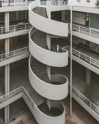 Man moving up on spiral staircase