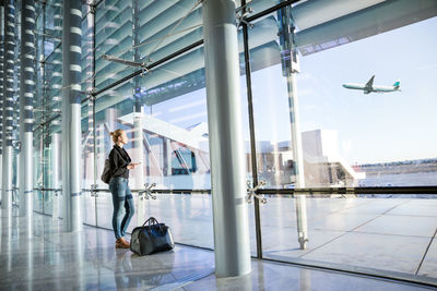 People at airport seen through glass window