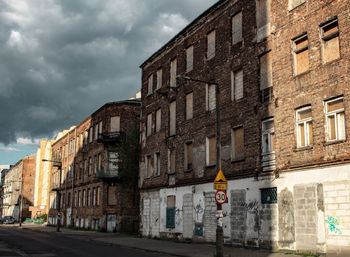 Buildings in city against cloudy sky