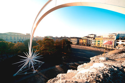 Scenic view of river by buildings against clear sky