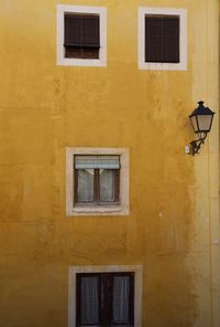 Low angle view of street light against building