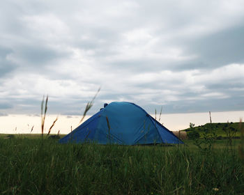 Tent on field against sky