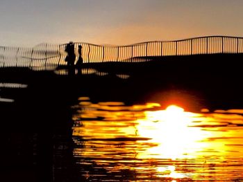 Silhouette of people at sunset