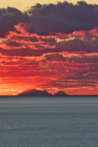 Scenic view of sea against romantic sky at sunset