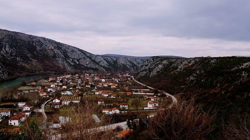 High angle view of houses and mountains against sky