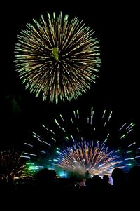 Low angle view of firework display at night