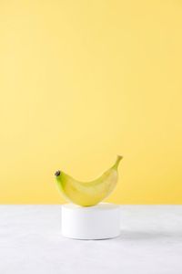 High angle view of orange fruit against yellow background