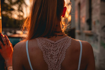 Midsection of woman with tattoo on neck