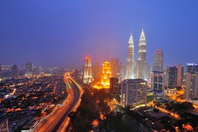 High angle view of city lit up at night