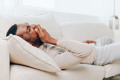 Man sleeping on bed at home