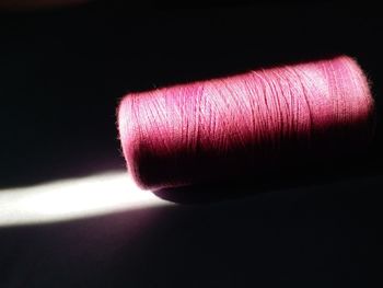 Close-up of pink object over black background