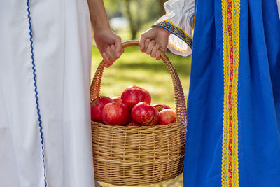 Woman with daughter holding apple basket