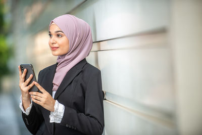 Mid adult woman using mobile phone