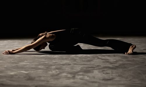 Woman with arms raised dancing on floor