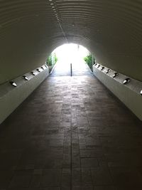 Walkway in illuminated tunnel