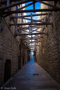 Empty alley amidst buildings in city