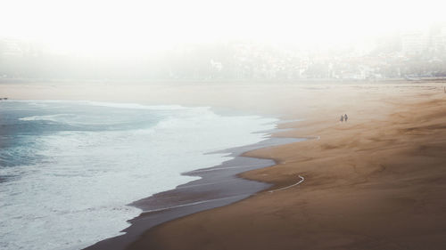Scenic view of beach in a foggy morning