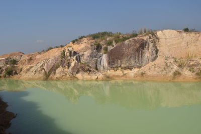 Scenic view of rock formations on landscape against sky