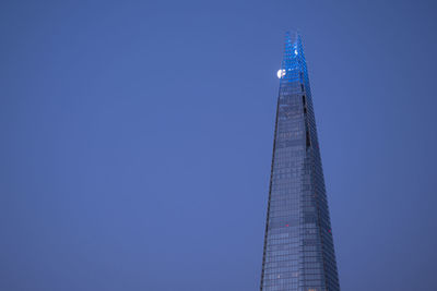 Low angle view of modern building against clear blue sky