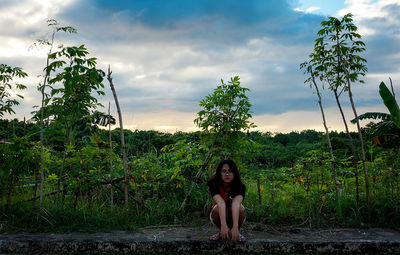 Full length of woman standing on field against sky