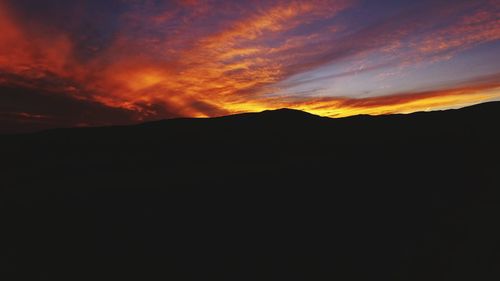 Scenic view of silhouette mountain against sky during sunset