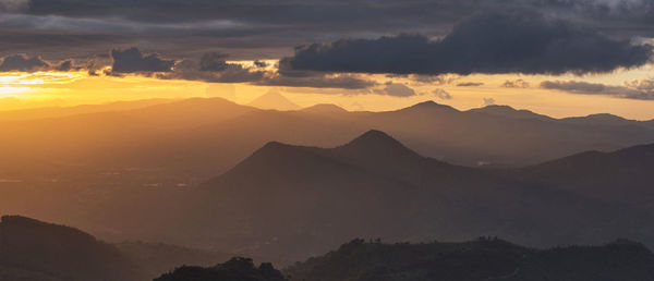 Scenic view of silhouette mountains against sky during sunset