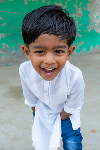 Portrait of smiling boy standing outdoors