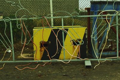 Metal fence against yellow wall