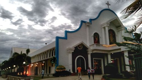 Low angle view of church against cloudy sky