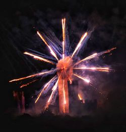 Low angle view of firework display at night