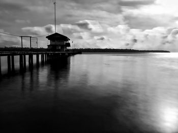 Scenic view of lake by building against sky