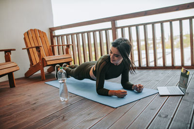 Woman sitting on table at home