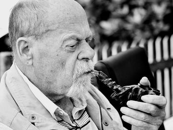 Close-up of man smoking pipe cigarette
