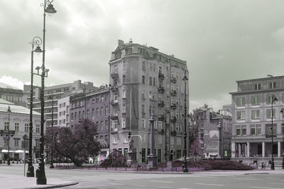 Buildings against cloudy sky