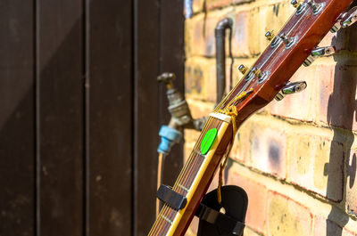 Close-up of guitar against wall