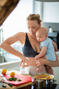 Side view of girl playing with drinks on table