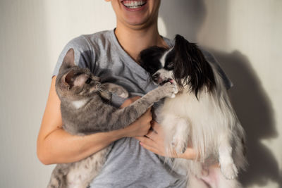 Midsection of woman holding pets