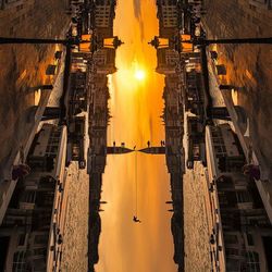 Reflection of buildings in water at sunset