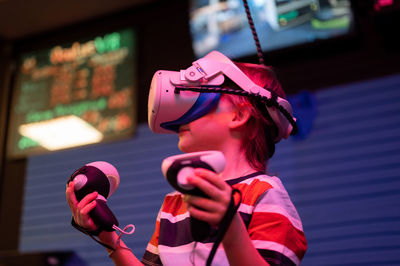 Vr game and virtual reality. kid boy gamer six years old fun playing on futuristic video game