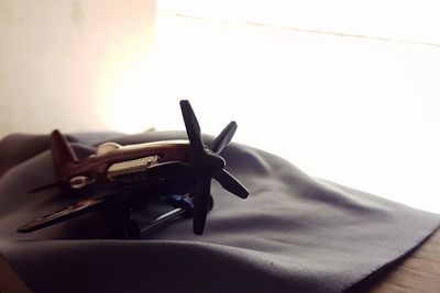 Close-up of hand holding pen on table