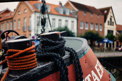 Close-up of rope against buildings in city