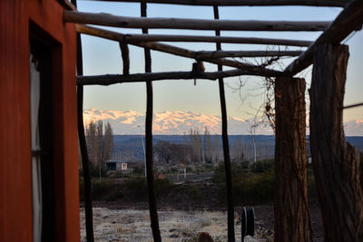 Abandoned house against sky during winter