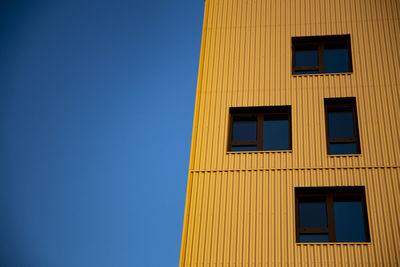 Low angle view of building against clear blue sky