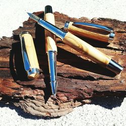 High angle view of pens on wood