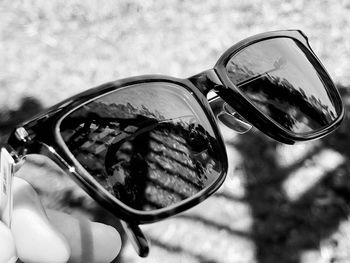 Close-up of hand holding sunglasses