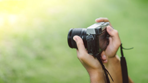 Midsection of woman photographing camera