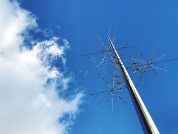 Low angle view of windmill against blue sky