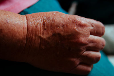 Close-up of wet wrinkled hand